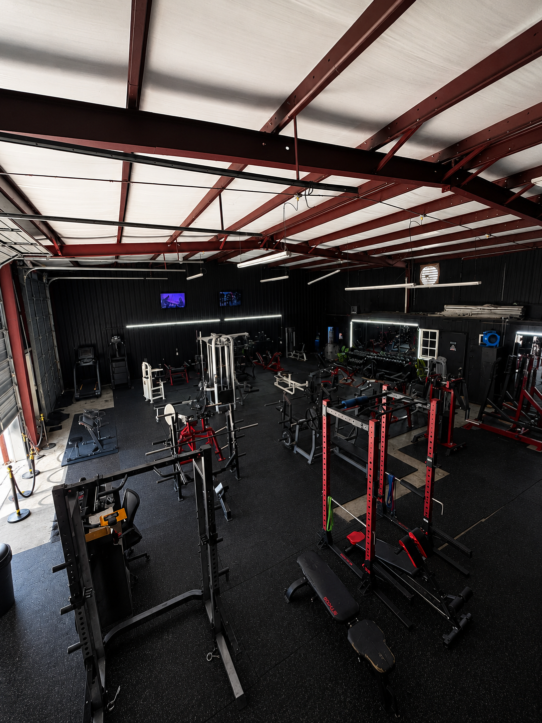 Overhead view of the Alpha Muscle training floor with racks and machines